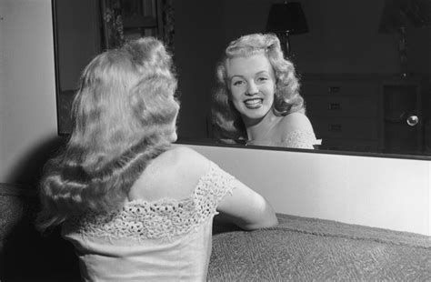 Marilyn Monroe looking in the mirror